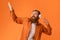 Redhaired Bearded Man Wearing Headphones Listens Music And Dances, Studio