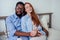 Redhaired ginger caucasian happy female and multi-ethnic afro man together lying in bed bedroom.lifestyle tolerance