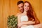 Redhaired ginger woman and her boyfriend steaming in the bathhouse with russian bunch broom.couple in love enjoying the