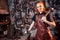 Redhaired ginger young european feminist woman wearing leather apron working blacksmith workshop.small business strong