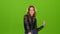 Redhaired girl begins to dance, she is in a good mood. Green screen. Time lapse