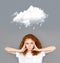 Redhaired girl under rainy cloud on gray background