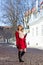 Redhaired girl walking in medieval european town