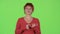 Redhaired woman thinks about her work. Green screen