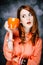 Redhead adult girl in coral shirt with cup of coffee