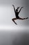 redhead ballerina in bodysuit jumping with