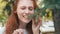 Redhead beautiful vegan girl eating pine needles