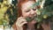 Redhead beautiful vegan girl eating pine needles