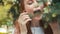 Redhead beautiful vegan girl eating pine needles