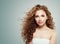 Redhead beauty. Young female face, woman with long healthy wavy hair