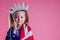 Redhead blonde charming female kid celebration independence holding a paper torch and diy crown and american flag on a