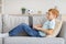 Redhead boy using laptop, playing online video game, side view