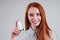 Redhead businesswoman tourist student in a striped shirt having asthma using the asthma inhaler for being healthy white