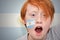 Redhead fan boy with argentinean flag painted on his face
