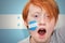 Redhead fan boy with honduran flag painted on his face