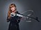 Redhead female Biathlon champion aiming with a competitive gun.