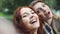 Redhead friends taking selfie with a smart phone and making faces and fun