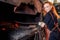 Redhead ginger woman blacksmith portrait in workshop