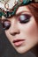 Redhead girl with bright makeup and big lashes. Mysterious fairy woman with red hair. Big eyes and colored shadows, long lashes