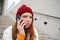 Redhead girl with concerned face, looking worried while answering phone call, hears bad news over telephone conversation