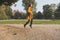 Redhead girl jumping in a city park