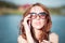 Redhead girl in sunglasses. close-up. emotions. Young redhead girl relaxing in sunglasses. woman relaxing outdoors. sinking eyes