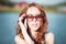 Redhead girl in sunglasses. close-up. emotions. Young redhead girl relaxing in sunglasses. woman relaxing outdoors. sinking eyes