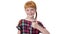 Redhead girl with two pigtails is showing thumb up gesture