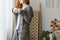 Redhead girl wearing warm grey sweater and holding coffee cup