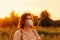 Redhead girl young woman wearing face mask and enjoy golden hour colors in nature. New reality routine