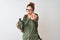 Redhead hiker woman wearing backpack holding canteen over isolated white background pointing with finger to the camera and to you,