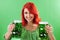 Redhead holding green beers