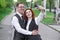 The redhead husband hugs his redhead wife. Wife takes selfie on smartphone.