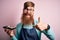 Redhead Irish cook man with beard holding maki sushi tray over isolated background happy with big smile doing ok sign, thumb up
