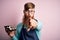 Redhead Irish cook man with beard holding maki sushi tray over isolated background pointing with finger to the camera and to you,