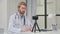 Redhead Male Doctor Recording Video on Camera