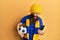 Redhead man with long beard football hooligan cheering game holding smartphone angry and mad screaming frustrated and furious,