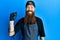 Redhead man with long beard tattoo artist wearing professional uniform and gloves with a happy and cool smile on face