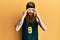 Redhead man with long beard wearing basketball uniform with hand on head for pain in head because stress