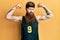 Redhead man with long beard wearing basketball uniform showing muscles skeptic and nervous, frowning upset because of problem
