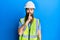Redhead man with long beard wearing safety helmet and reflective jacket asking to be quiet with finger on lips