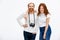 Redhead photographer dressed in white jacket standing near redhe