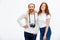 Redhead photographer dressed in white jacket standing near redhe