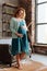 Redhead pregnant woman in turquoise apparel