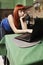 Redhead pregnant working on laptop