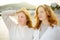 Redhead senior mother and her beautiful adult daughter are walking together and laughing