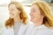 Redhead senior mother and her beautiful adult daughter are walking together and laughing