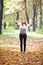 Redhead teenager throwing leaves in the forest