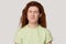 Redhead unhappy capricious woman closed eyes frowning eyebrows studio headshot