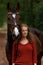 Redhead woman brown mare horse forest autumn